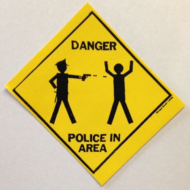 Cat.No: 217439 Danger: Police in Area [sticker]. October 22 Coalition to Stop Police Brutality.