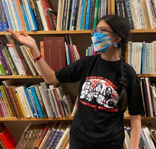 [X-LARGE t-shirt] Bolerium Books (design based on a Chinese poster celebrating internationalism. Chinese text above says "Proletarians of the world, unite!" Bolerium Books is repeated in English and Chinese)