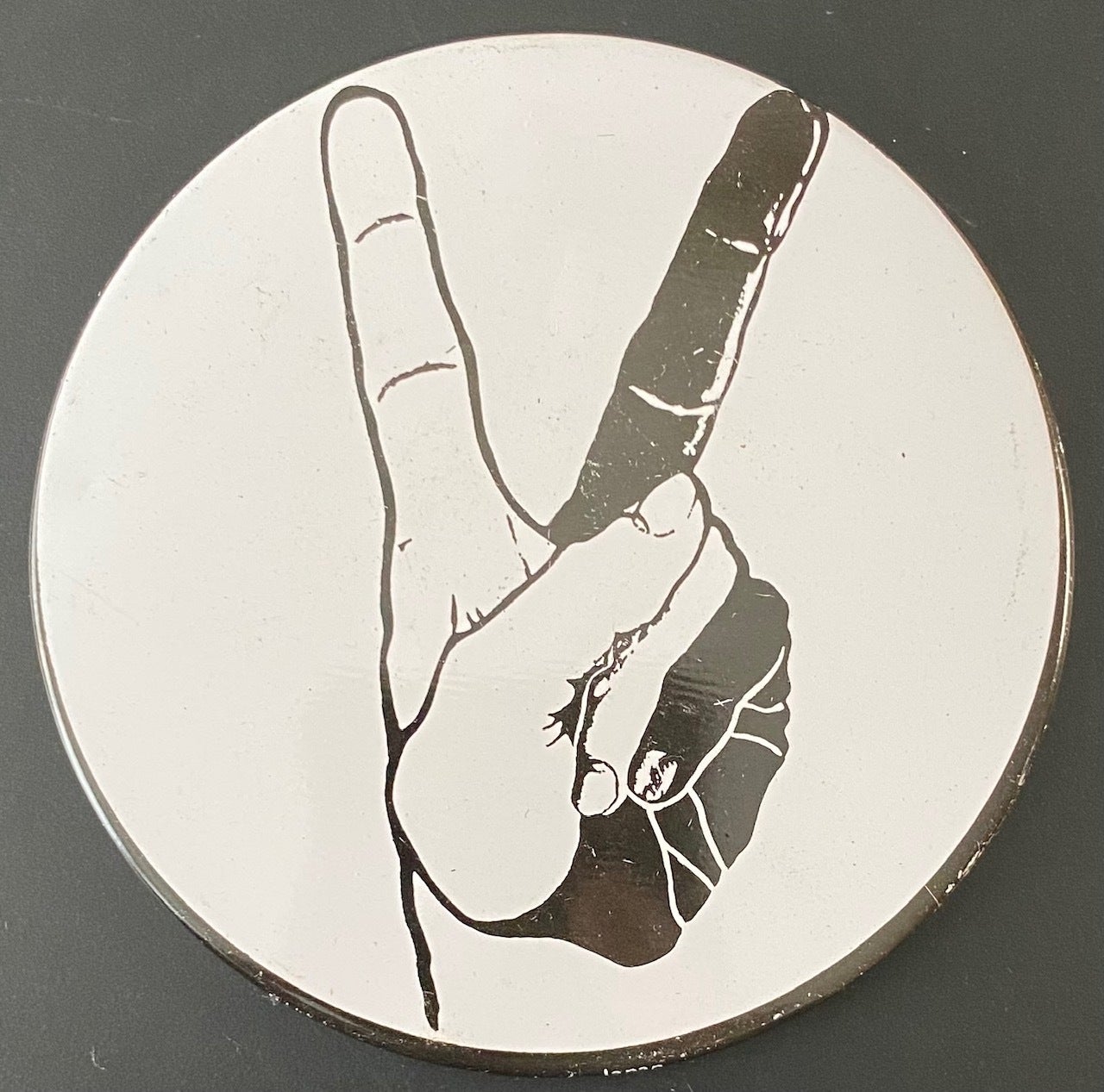 Large pin depicting two-color hand flashing peace sign
